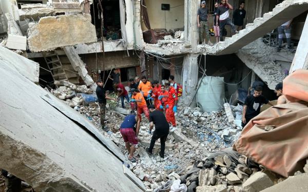 Locals and rescue teams at work in a damaged building following an overnight Israeli airstrike on the Ain al-Helweh refugee camp on the outskirts of Sidon City in Lebanon.