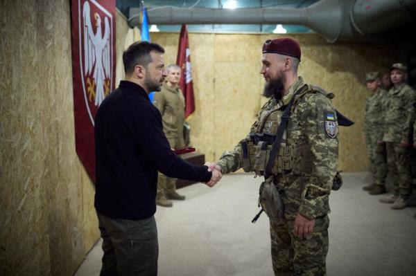 Ukraine's President Volodymyr Zelenskiy shakes hands with a service member during his visit to a position of Ukrainian troops, in the course of Russia-Ukraine conflict, in Sumy region, Ukraine October 4, 2024. Ukrainian Presidential Press Service/Handout via REUTERS ATTENTION EDITORS - THIS IMAGE HAS BEEN SUPPLIED BY A THIRD PARTY.