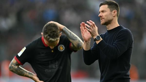 Grim-aldo: The Leverkusen defender (L) and manager Xabi Alo<em></em>nso react at full-time