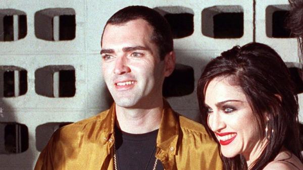 FILE - Mado<em></em>nna poses with her brother, Christopher Ciccone, left, and director Alek Keskishian following the premiere showing of Madonna's newest film, "Truth or Dare," May 7, 1991, in the Hollywood section of Los Angeles. (AP Photo/Julie Markes, File)