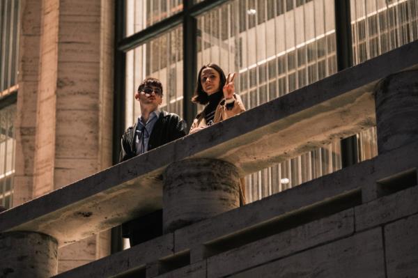 Ballet goers look out of the balcony of the Koch Theater
