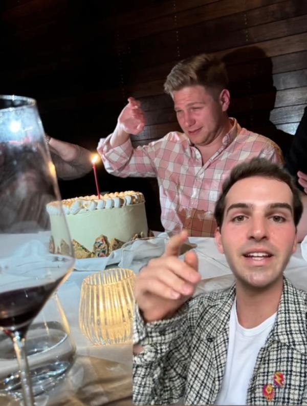 Screenshot of Ryan Nordheimer's TikTok video showing the birthday cake in front of his friend at the table